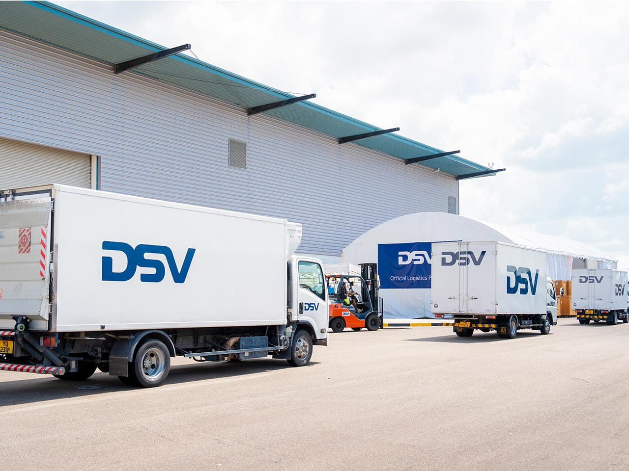 DSV trucks being loaded at an Office Logistics warehouse.